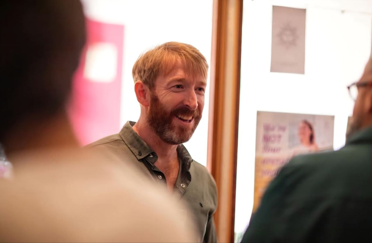 Kieran Dowling in conversation with men at a Rose & Sword event